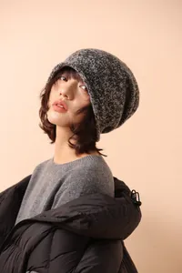 Detail of grey melange 100% wool knitted beanie featuring a warm and loose fit design