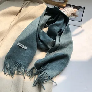Detail of 100% Australian wool blue scarf with long tassels and premium texture
