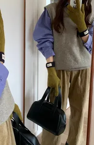 Touchscreen knitted gloves in olive green and black color block with stylish woven label