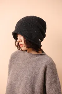 Detailed knit texture of a dark grey wool beanie with colorful speckled fiber accents