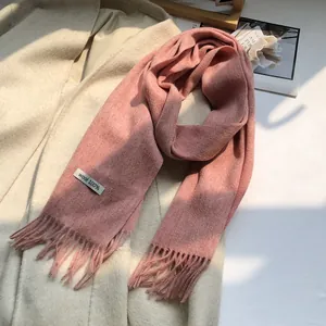 Close-up of pink 100% Australian wool scarf featuring soft fringe and thick knit texture