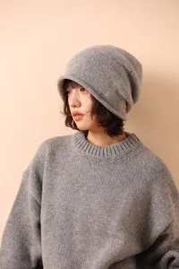 Close-up of light grey pure wool knit beanie showing fine texture and rolled brim style