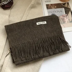 Close-up of 100% Australian wool scarf in dark brown with elegant tassel detail