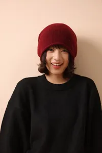 Detail view of the fine knit texture and soft dark red 100% wool material on this winter beanie
