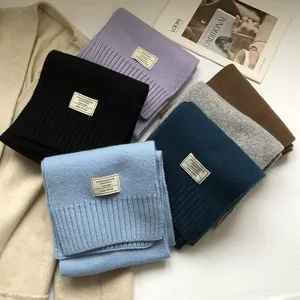 Detail of 100% pure Australian wool scarves in multiple colors with quality fabric labels