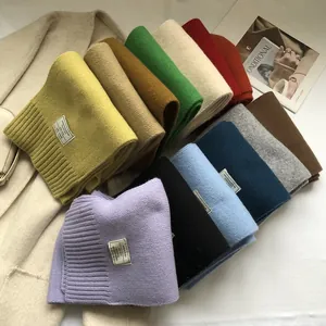 Close-up of thick 100% Australian wool scarves showing textured knit and decorative labels