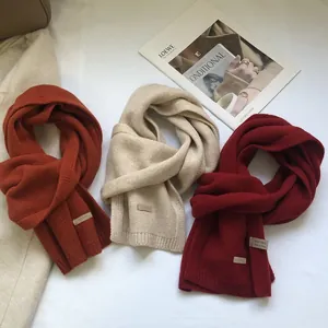 Close-up of 100% Australian wool scarves showing the authentic knit texture and wool labels