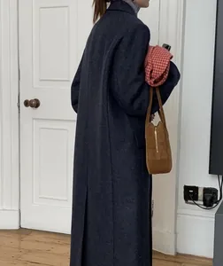 Detail view of the back slit and texture on this long wool blend coat for winter