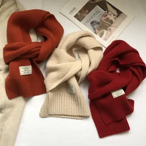 100% Australian wool scarves in beige and burnt orange with soft ribbed texture