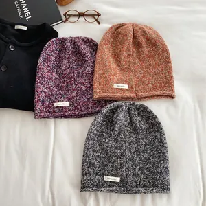 Trio of 100% pure wool knit beanies in assorted colors with branded fabric labels