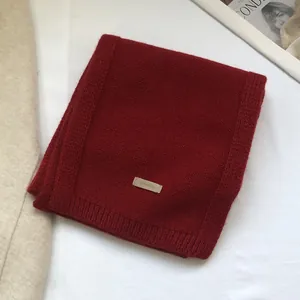 Detail showing deep red 100% Australian wool scarf with fine ribbed knit texture