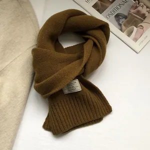 Close-up of 100% Australian wool scarf in dark caramel with ribbed knit texture
