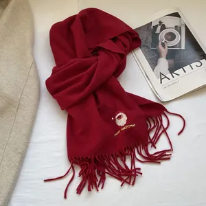 Detail of red Christmas scarf featuring Santa embroidery and Merry Christmas text