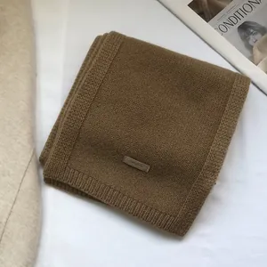 Macro shot of 100% pure Australian wool scarf with rib-knit texture in camel brown