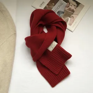 Detail of red 100% Australian wool scarf featuring premium ribbed knit texture and soft feel