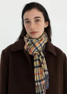 Detail of multi-color plaid wool scarf with fringe texture and autumn styling