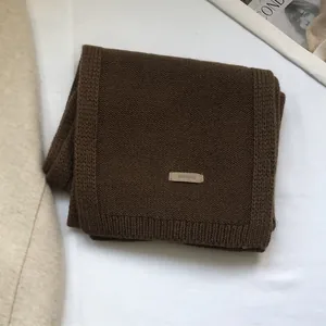 Close-up of 100% Australian wool scarf showing soft knit texture in chocolate brown