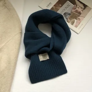 Detail shot of the 100% Australian wool scarf in navy blue with knitted texture