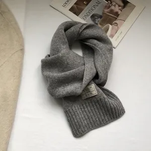 Detailed view of 100% Australian wool scarf with ribbed texture and woven label