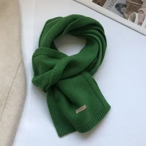 Detailed view of the soft green 100% Australian wool scarf with fine knit texture