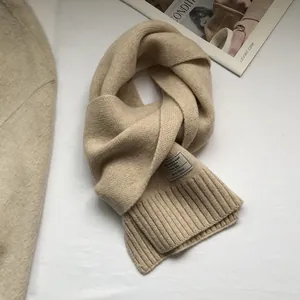 Detail showing 100% Australian wool texture and beige knitted fabric with brand label