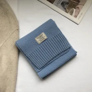 Detailed view of blue 100% Australian wool scarf with stitched fabric material label