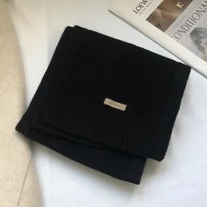 Detail view of black 100% Australian wool scarf with stitched material label