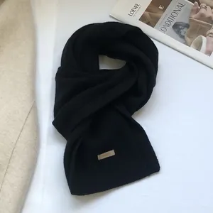 Detailed close-up of 100% Australian wool scarf texture with material label on a white background