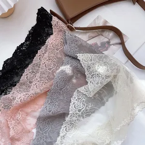 Detail of delicate rose lace fabric in black pink grey and beige for head scarves