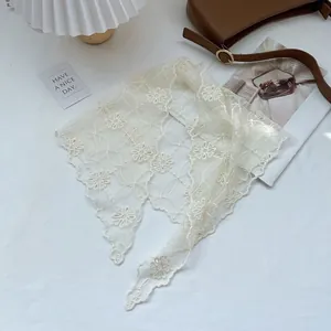 Elegant cream lace triangle headscarf with daisy floral embroidery on white fabric