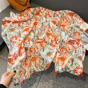 Linen feel floral scarf with orange flower prints and fringe tassels for women