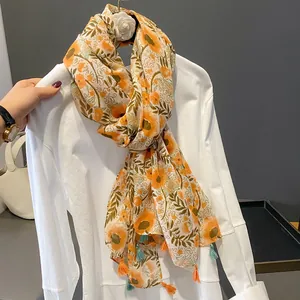 Lightweight cotton-linen floral scarf with orange flower print and tassel trim for women