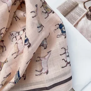 Close-up of printed cotton scarf with horse pattern and vintage fringe tassels detail