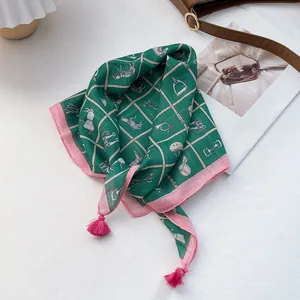 Detailed macro view of equestrian pattern scarf with pink tassels and vintage fringe