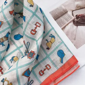 Detail of equestrian printed cotton scarf featuring vintage horse motifs and orange hem