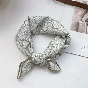Light green cotton floral bandana with white botanical print and stylish knotted design