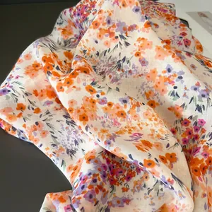 Detail of pink floral cotton scarf fabric with light texture and elegant drape