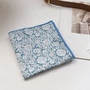 Detail of blue and white floral cotton scarf with precise overlock edge stitching