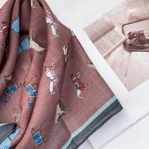 Detail of vintage silk scarf featuring colorful horse prints and elegant tassels
