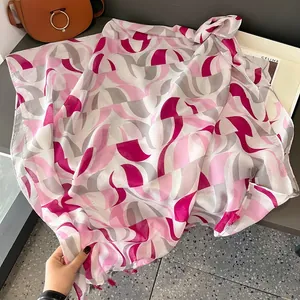 Modern geometric print silk scarf with pink and grey patterns and tassel edges