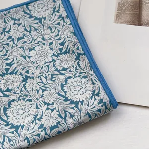 Detailed close-up of a floral cotton square scarf with a blue vintage zipper design