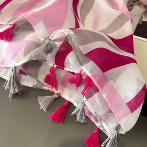 Modern printed beach shawl with magenta geometric patterns and tassel fringe details