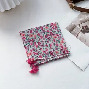Detail of floral square scarf with pink tassels and breathable cotton linen texture