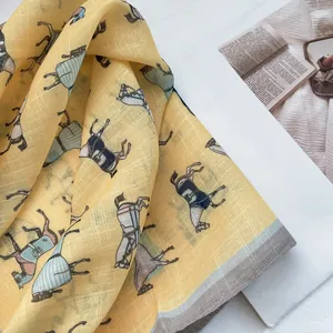 Detail of yellow cotton-linen scarf featuring vintage horse prints and neat edge stitching