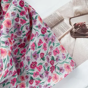 Close-up of floral scarf fabric with breathable mesh texture and elegant French props