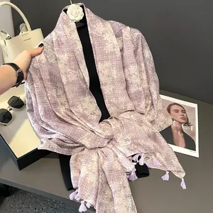 Light purple abstract print scarf with tassel edges displayed on a chic model stand