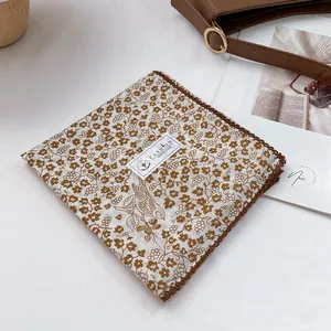 Detail showing 100% cotton floral bird print with brown crochet lace trim edges