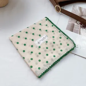 Detail of 100% cotton square scarf with green polka dots and crochet lace edges