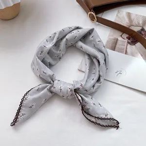 Detail of floral cotton square scarf featuring elegant crochet lace edges in retro style