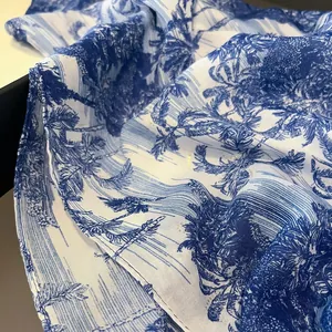 Blue and white palm leaf toile de jouy print scarf with elegant tassels and silk texture